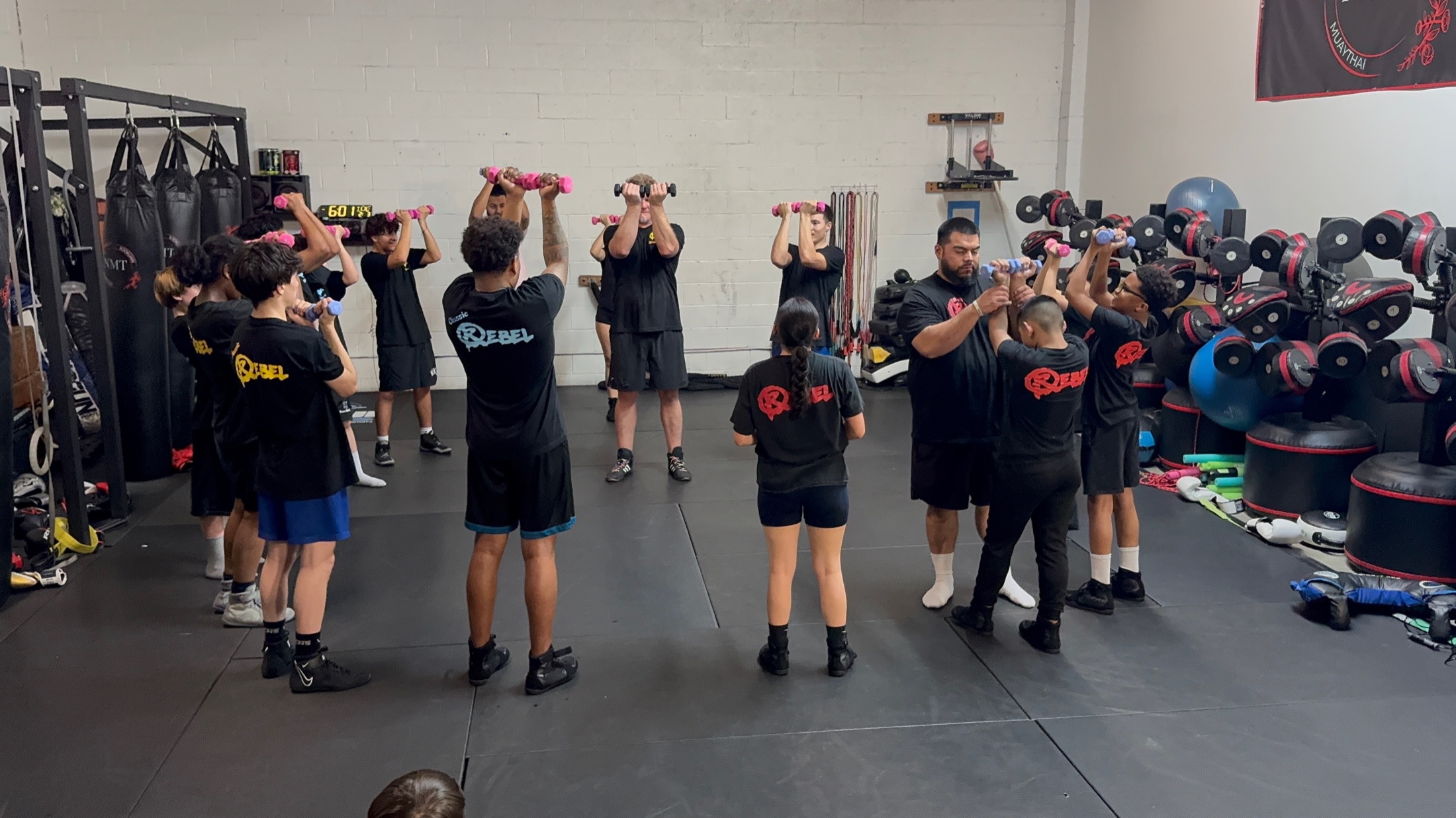 Rebel One athletes training together in a circle